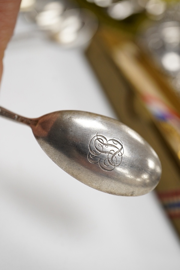 A cased set of six George V silver teaspoons and pair of sugar tongs, by Walker & Hall, Sheffield, 1918, together with a set of ten sterling coffee spoons, with floral terminals, a sterling tea strainer and a boxed Eliza